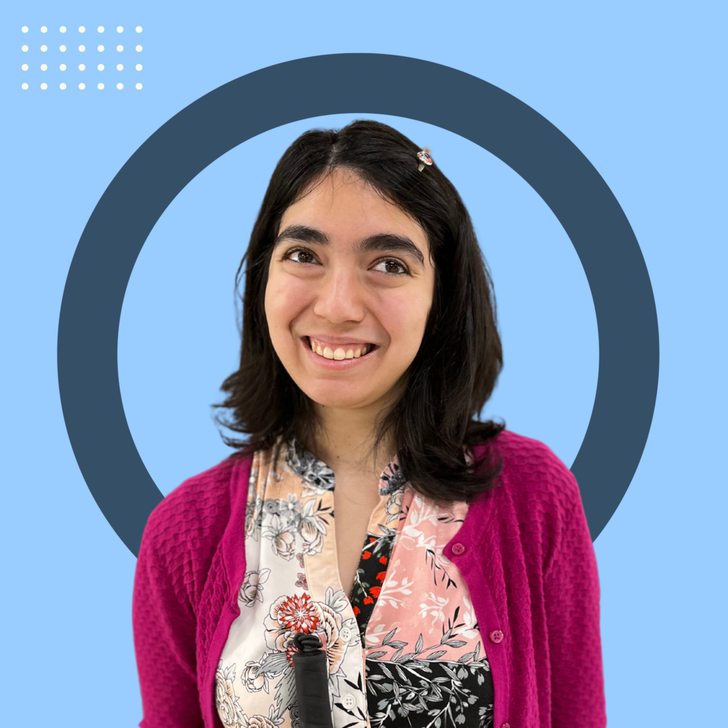 A blue background with small white dots in a row thats 7 x 4 on the left top. In the center, there is a large blue outlined circle with Lily Alvarez in front. She has shoulder length black hair and is smiling. She is wearing a Magenta colored cardigan and a light pink, grey and white floral blouse.