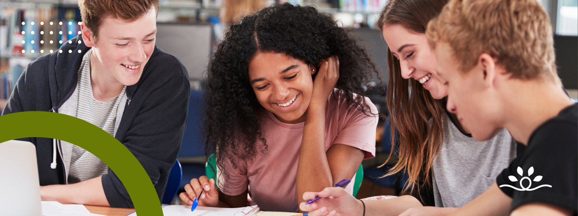 A wide horizontal design featuring four students seated at a library table, working together with notebooks and pens, smiling as they collaborate. A dark olive-green arc curves from the bottom left, while dotted white graphics appear near the top left. The white National Disability Center logo is placed on the lower right.